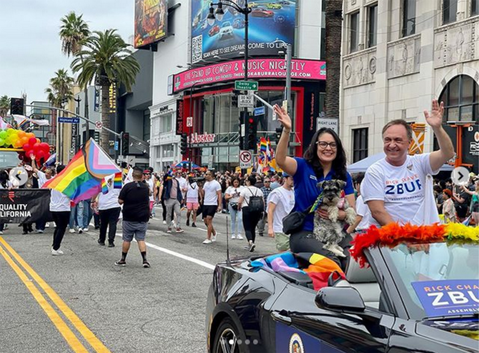 Asm. Zbur and guest sitting on top of backseat of parade car