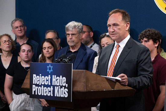 Asm. Zbur at podium, speaking, while guests listen on