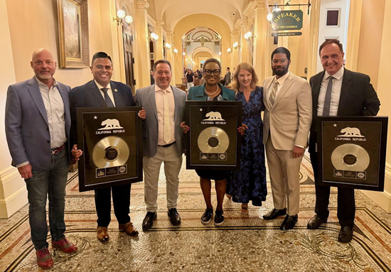 Asm. Zbur with representatives of UMG and legislators, holding awards