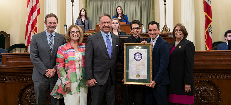 Abbe Land being honored by Asm. Zbur and Speaker Rendon