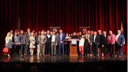 Friends, family, and colleagues surround Asm. Zbur on stage