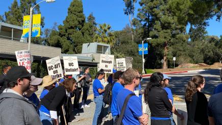 Protesters standing in street, some holding signs
