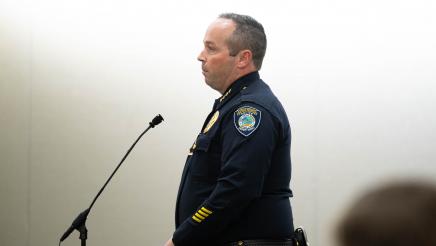 Peace officer at standing microphone