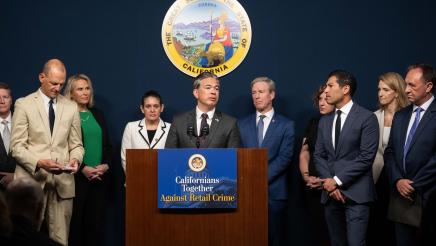 Asm. Zbur stands in support as Attorney General Rob Bonta speaks at podium