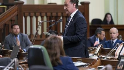 Asm. Zbur standing and speaking into microphone on the Assembly Floor
