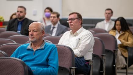 Audience members listening on