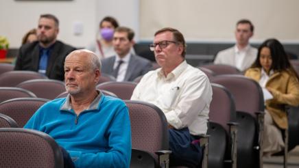 Audience members listening on