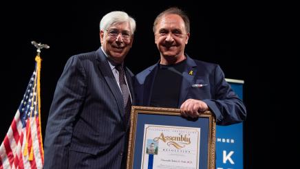 Hon. Dr. Julian Gold receives the AD51 Community Excellence Award for Distinguished Service in Local Government.