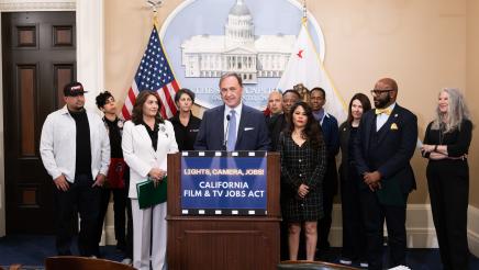Asm. Zbur at podium, speaking, with other members and supporters in background