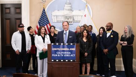 Asm. Zbur at podium, speaking, with other members and supporters in background