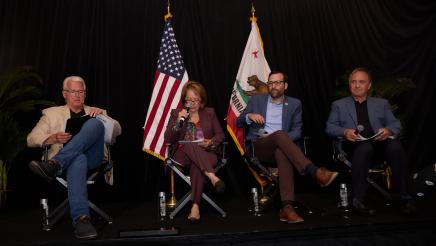Asm. Zbur seated onstage with fellow presenters